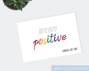 Poppleberry A6 positivity postcard, with an uplifting rainbow-coloured message "Stay positive", on white cardstock.
