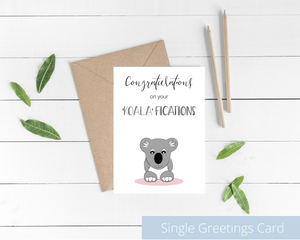 Poppleberry A6 folded congratulations card, with a smiling koala digital illustration, on white cardstock and kraft brown envelope.