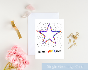 Poppleberry A6 folded greetings card, with a rainbow-coloured star illustration, on white cardstock and white envelope.