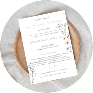 Pastel wildflower A6 Poppleberry wedding evening / reception invitation on white cardstock, laid on wooden plate.