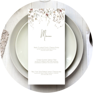 A Poppleberry neutral-shaded foliage wedding menu card, printed with 3-course dinner menu, laid on dining table with cutlery and glasses.