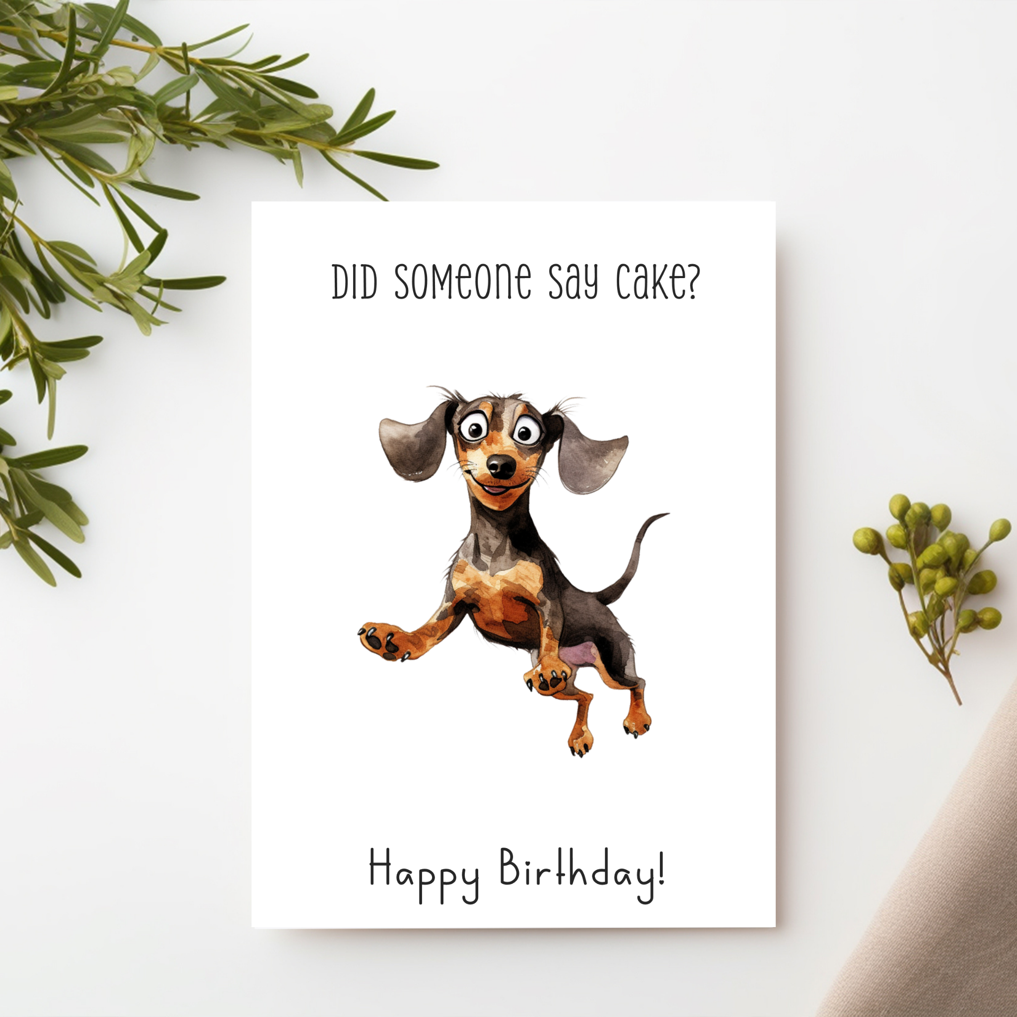 a Happy Birthday card with a cute dachshund dog looking excited picture on a white background with text above saying "Did someone say cake?" and underneath the picture the text Happy Birthday!
