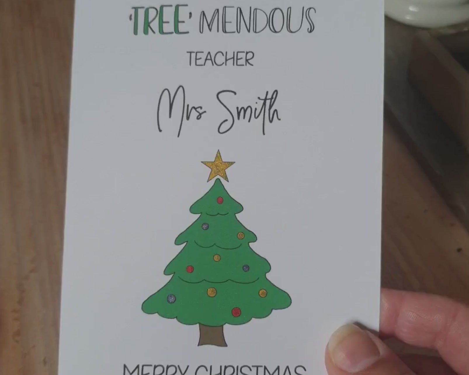 Poppleberry A6 'Tree-mendous' Personalised & Glittered Teacher Christmas Card on White Cardstock, tilted to show sparkle.