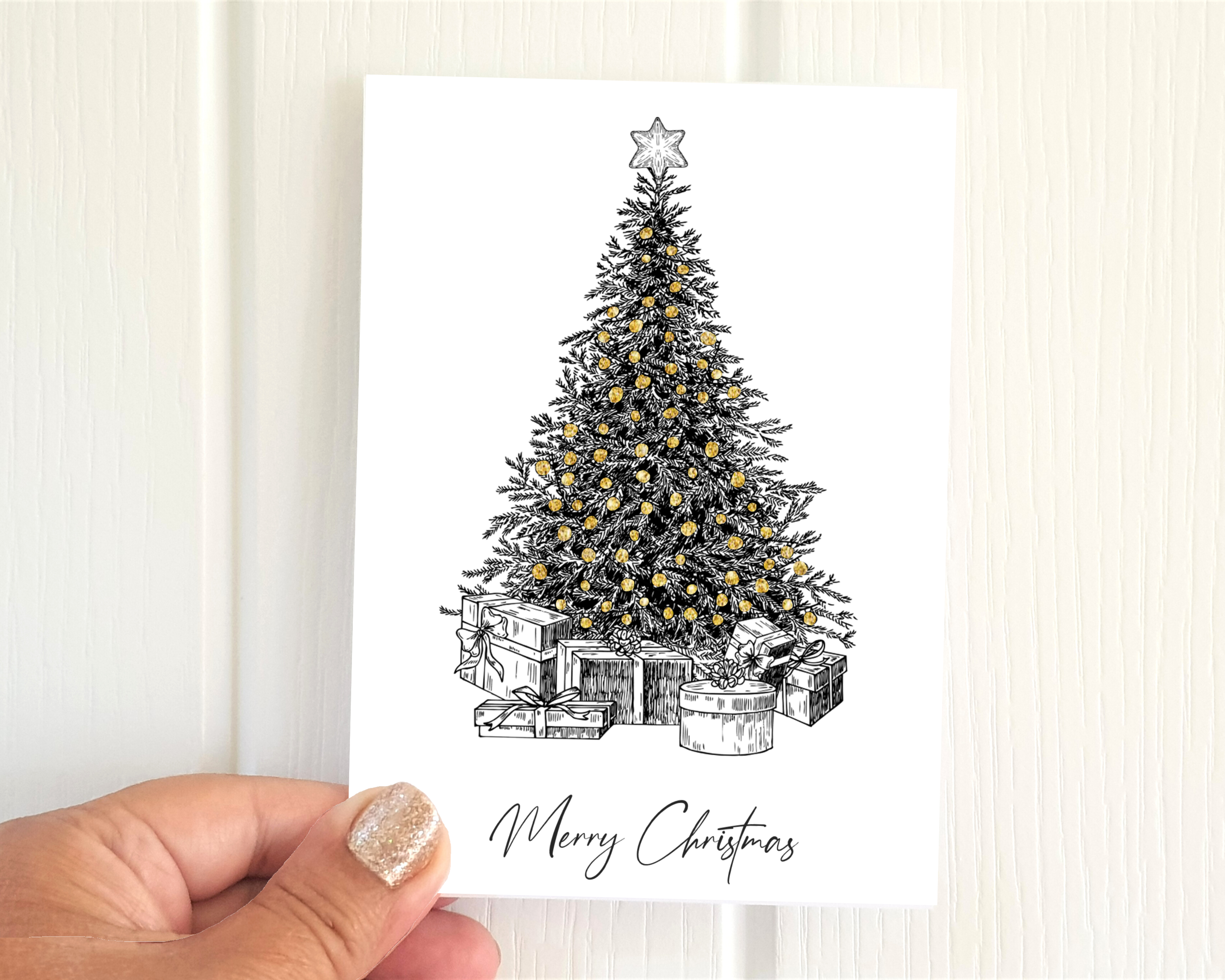 Poppleberry A6 Tree Illustration Golden Glittered Christmas Cards on White Cardstock, size compared to thumb.