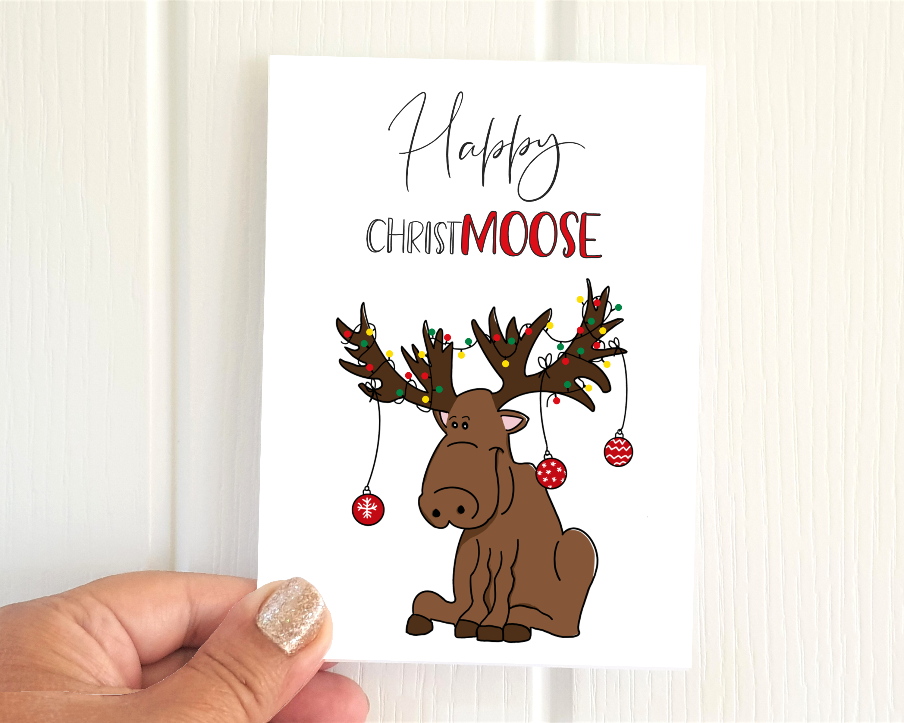 Poppleberry A6 'Happy Christ-moose' Glittered Christmas Cards on White Cardstock, size compared to thumb.