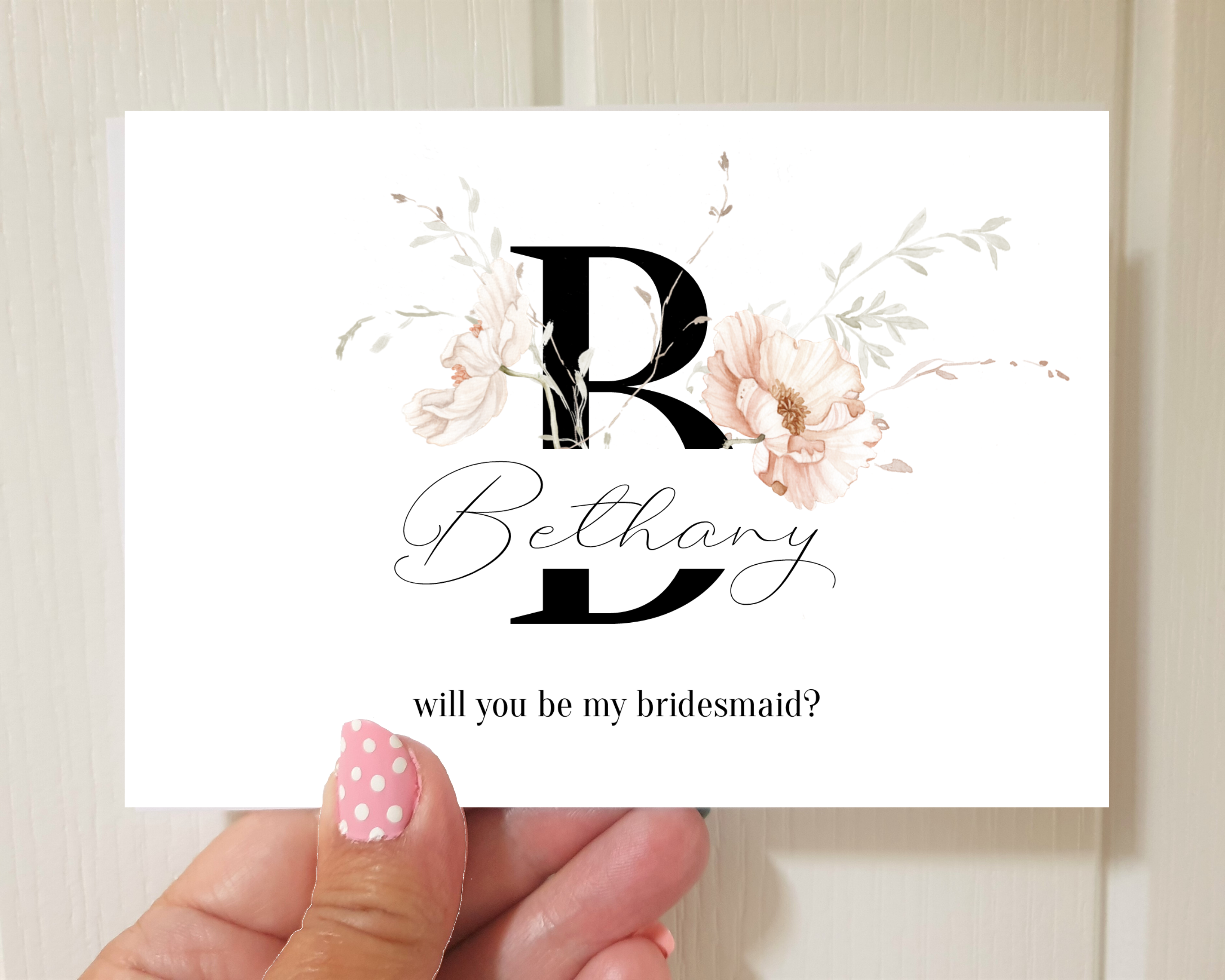 Front of an Icelandic poppy A6 Poppleberry 'Will you be my...?' bridesmaid proposal card, held to show size.