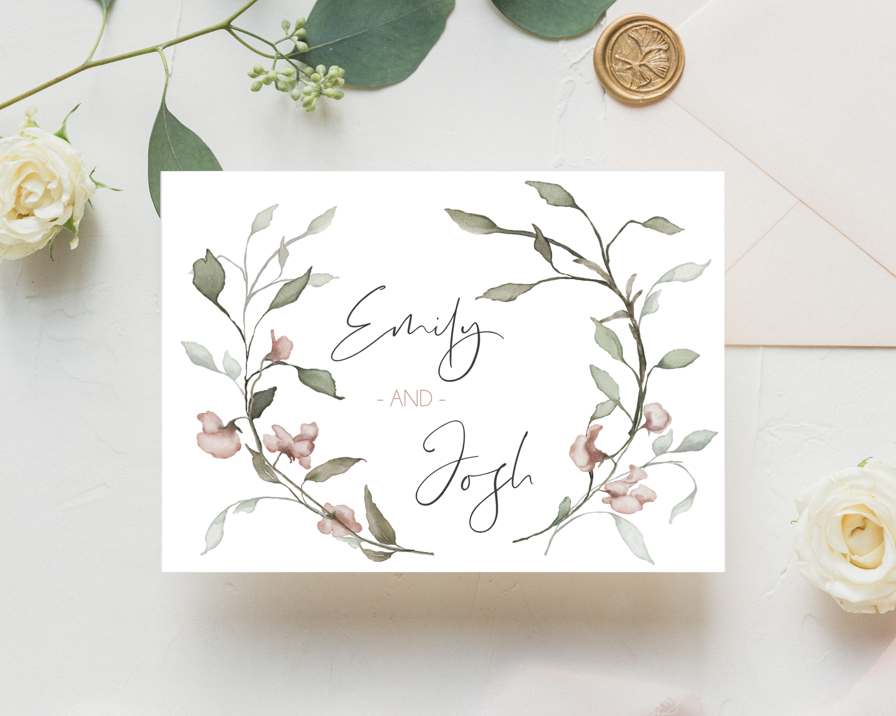 Watercolour Pink Flowers A6 Poppleberry accordion fold all-in-one wedding invitation, folded on eucalyptus leaves.