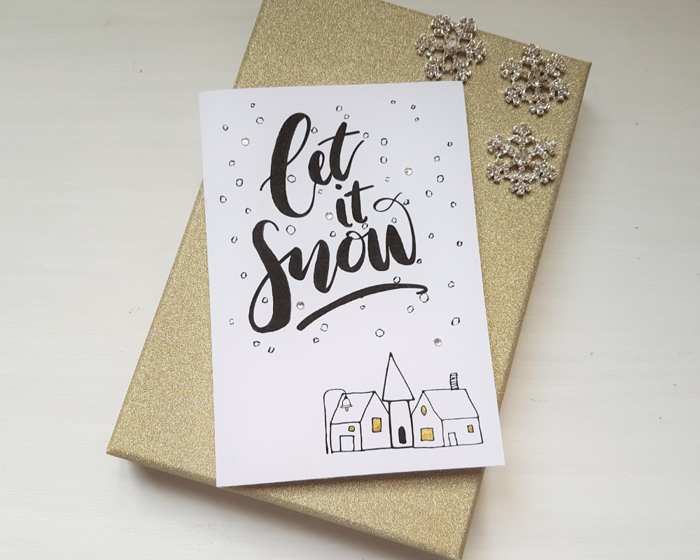 Poppleberry A6 'Let it Snow' Scandinavian - Inspired Folded Christmas Card with Snow & Village Illustration.