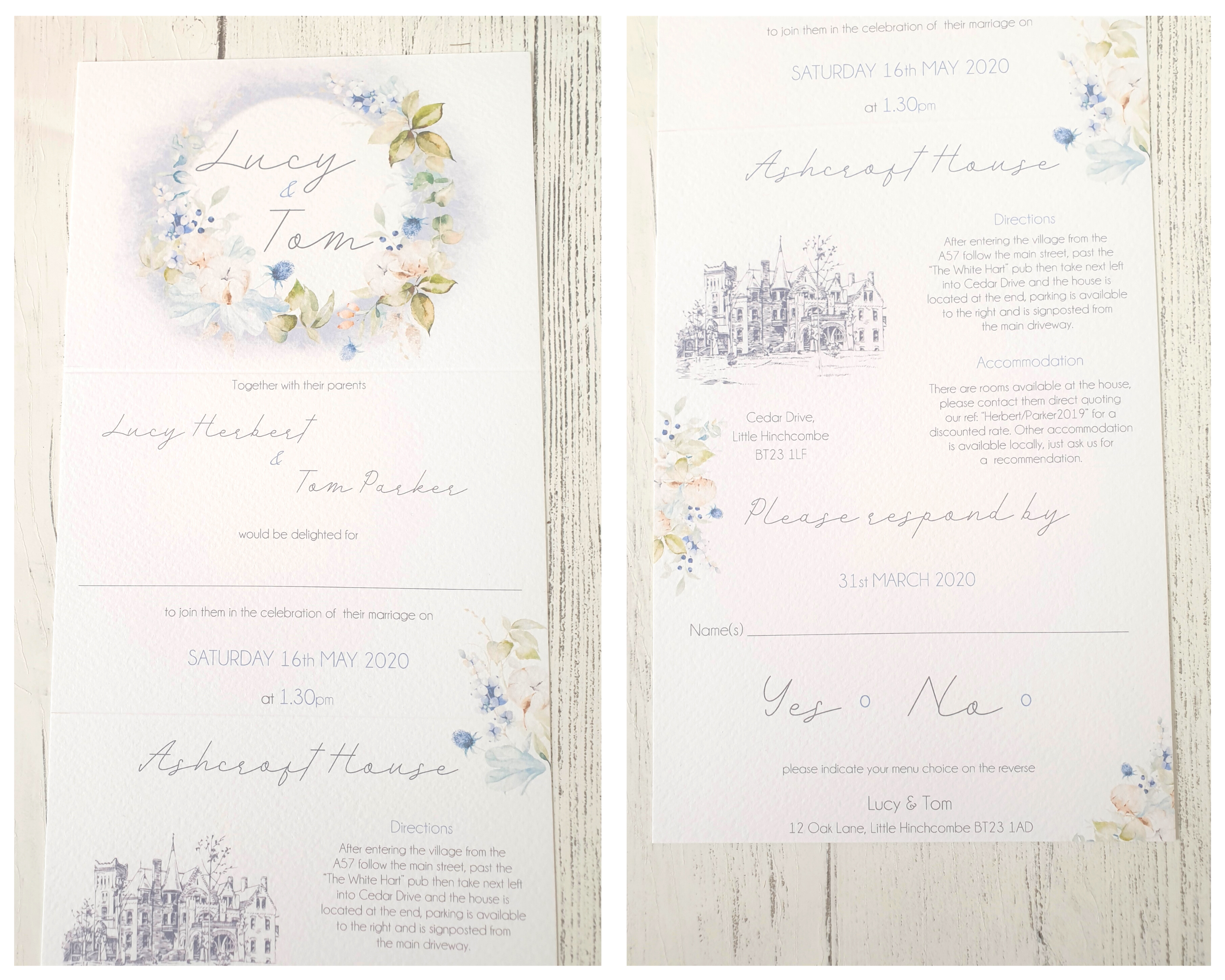 Close-up of the front of an unfolded dusty blue & cotton A6 Poppleberry accordion fold all-in-one wedding invitation.