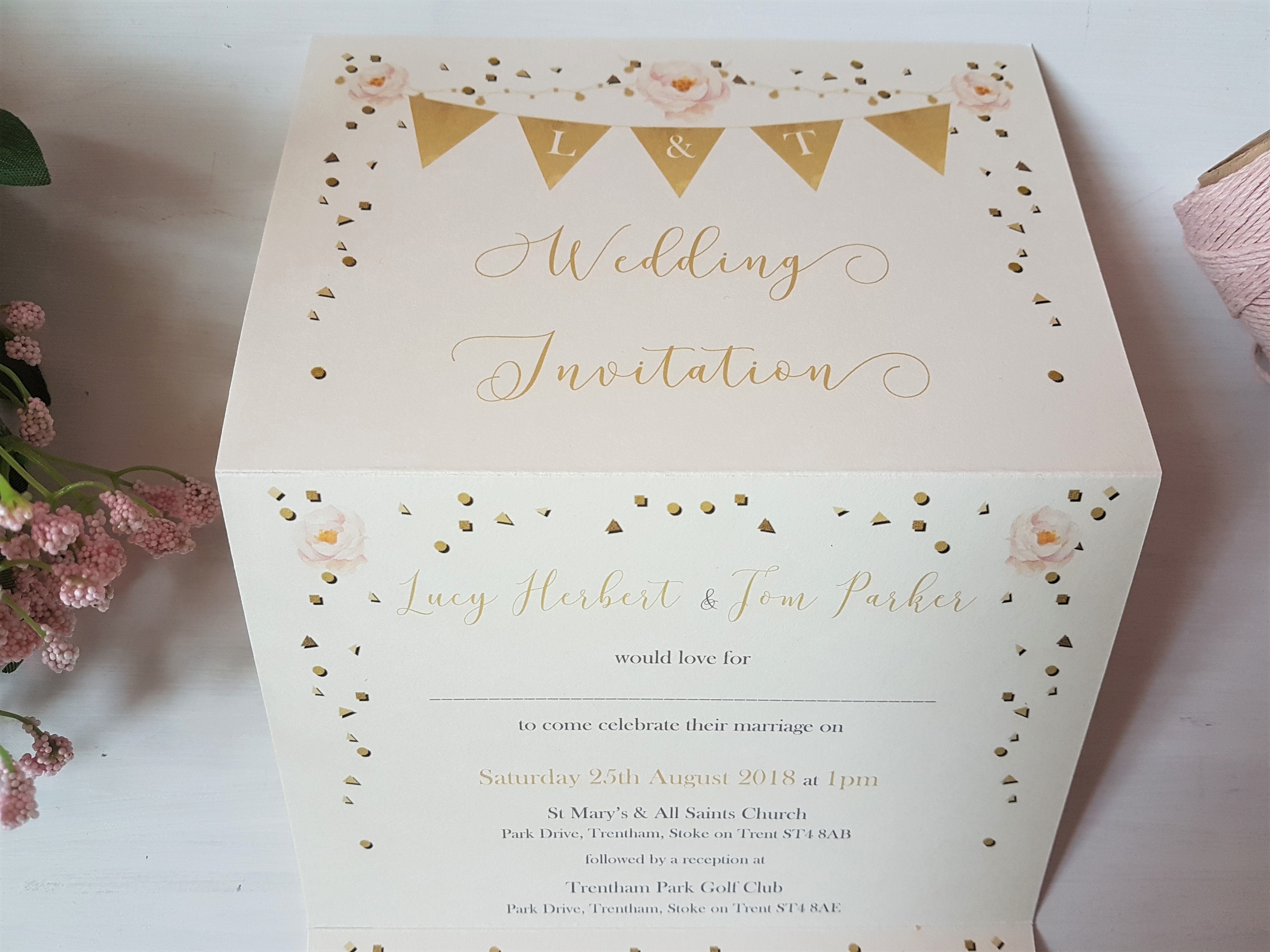 Close-up of the top half of an unfolded golden bunting A6 Poppleberry accordion fold all-in-one wedding invitation.