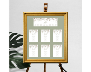 A set of Poppleberry neutral-shaded foliage wedding table plan cards, including 'top table' and 'A6 table' cards, framed.